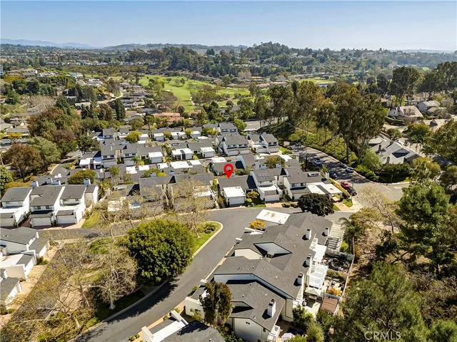 an aerial view of residential houses with city view