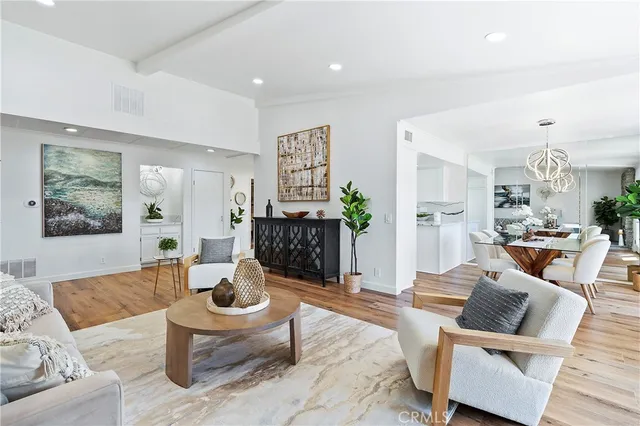 a living room with furniture and view of kitchen