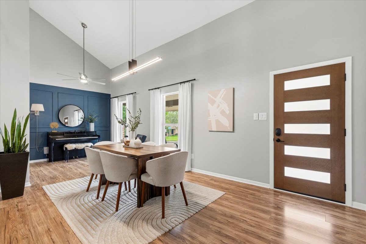 208 Skyloop Drive Austin, TX 78745 - Photo 5 of 34 Light-filled dining space with soaring ceilings, updated flooring, and open-concept design.