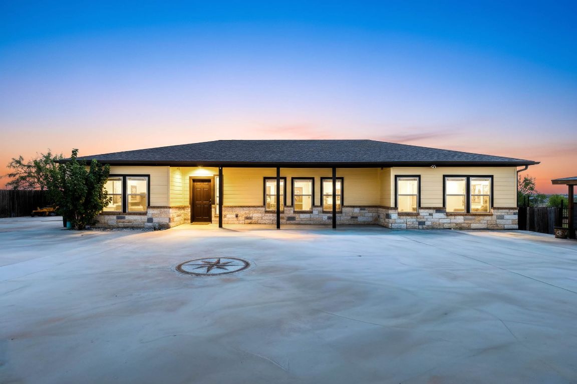 a view of an house with backyard and porch
