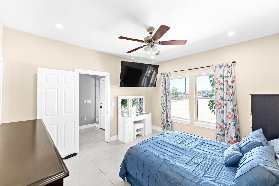 749 El Rey Drive Kyle, TX 78640 - Photo 19 of 40 a bedroom with a large bed and a window