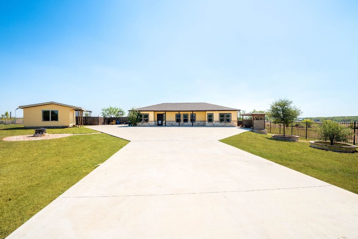 749 El Rey Drive Kyle, TX 78640 - Photo 2 of 40 a house view with swimming pool in front of it
