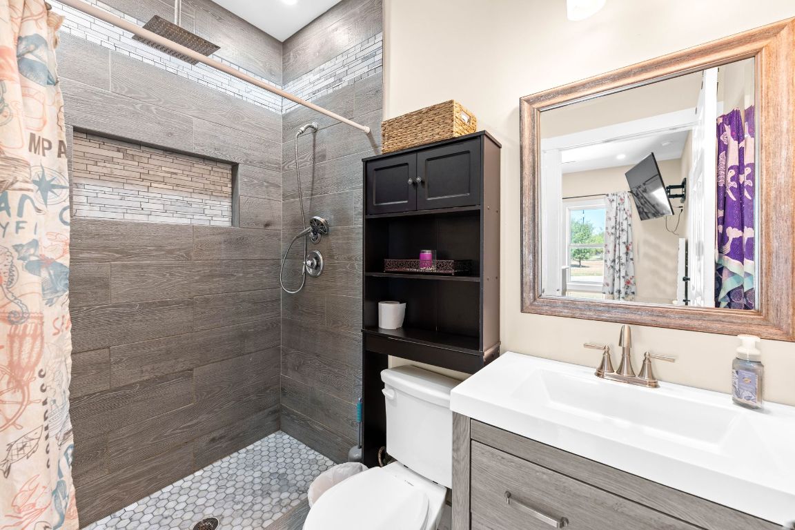 749 El Rey Drive Kyle, TX 78640 - Photo 22 of 40 a bathroom with a sink toilet vanity and shower