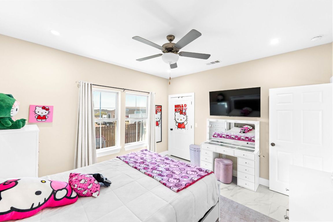 749 El Rey Drive Kyle, TX 78640 - Photo 25 of 40 a bedroom with a bed dresser and flat screen tv