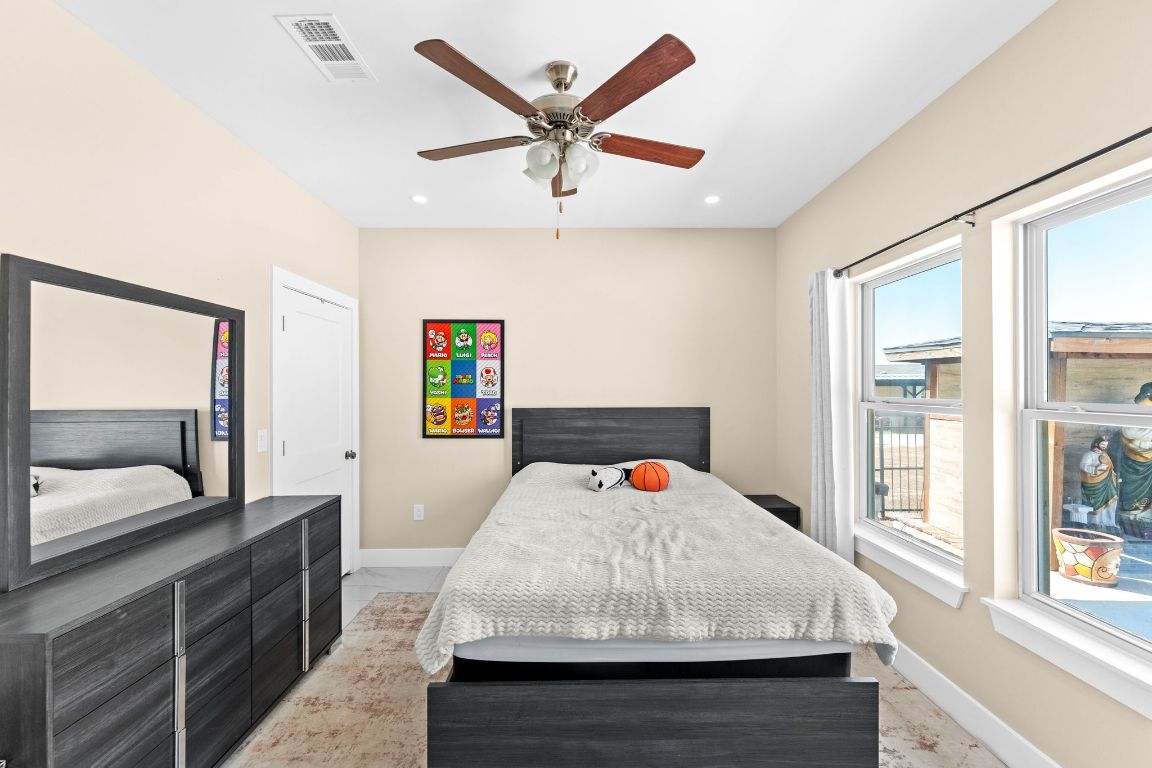 749 El Rey Drive Kyle, TX 78640 - Photo 27 of 40 a bedroom with a bed and a large window