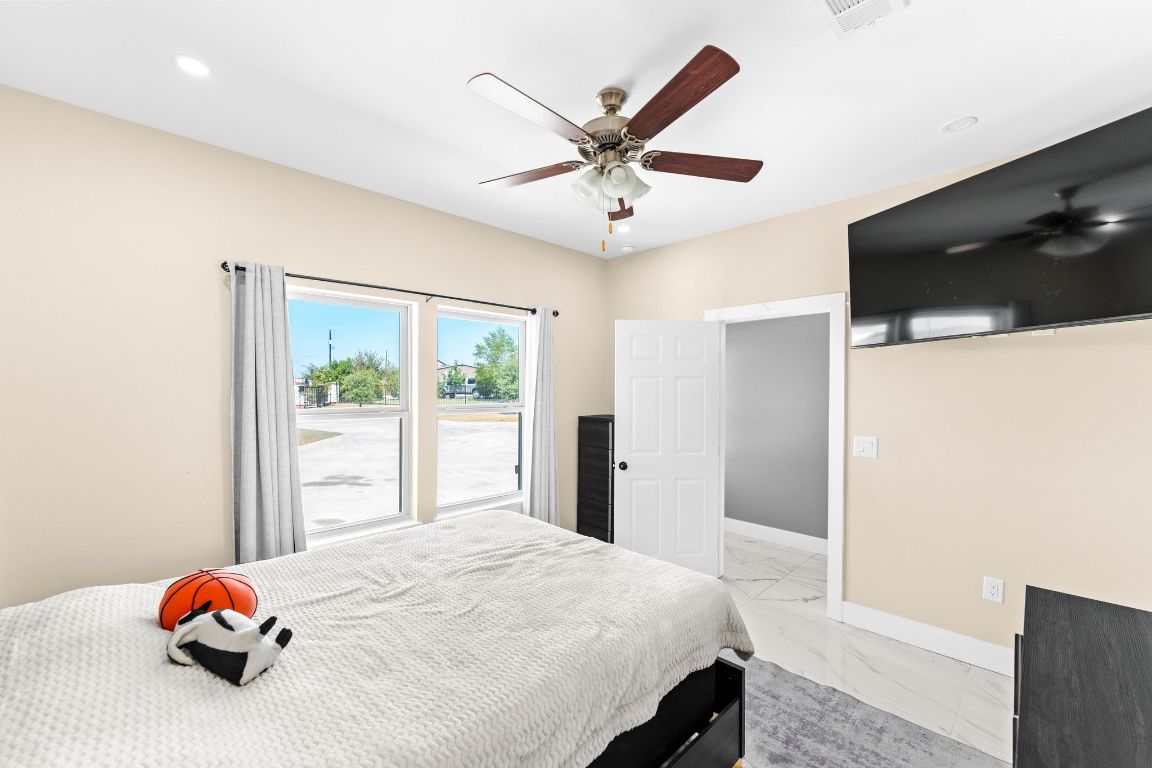 749 El Rey Drive Kyle, TX 78640 - Photo 28 of 40 a bedroom with a bed and a large window