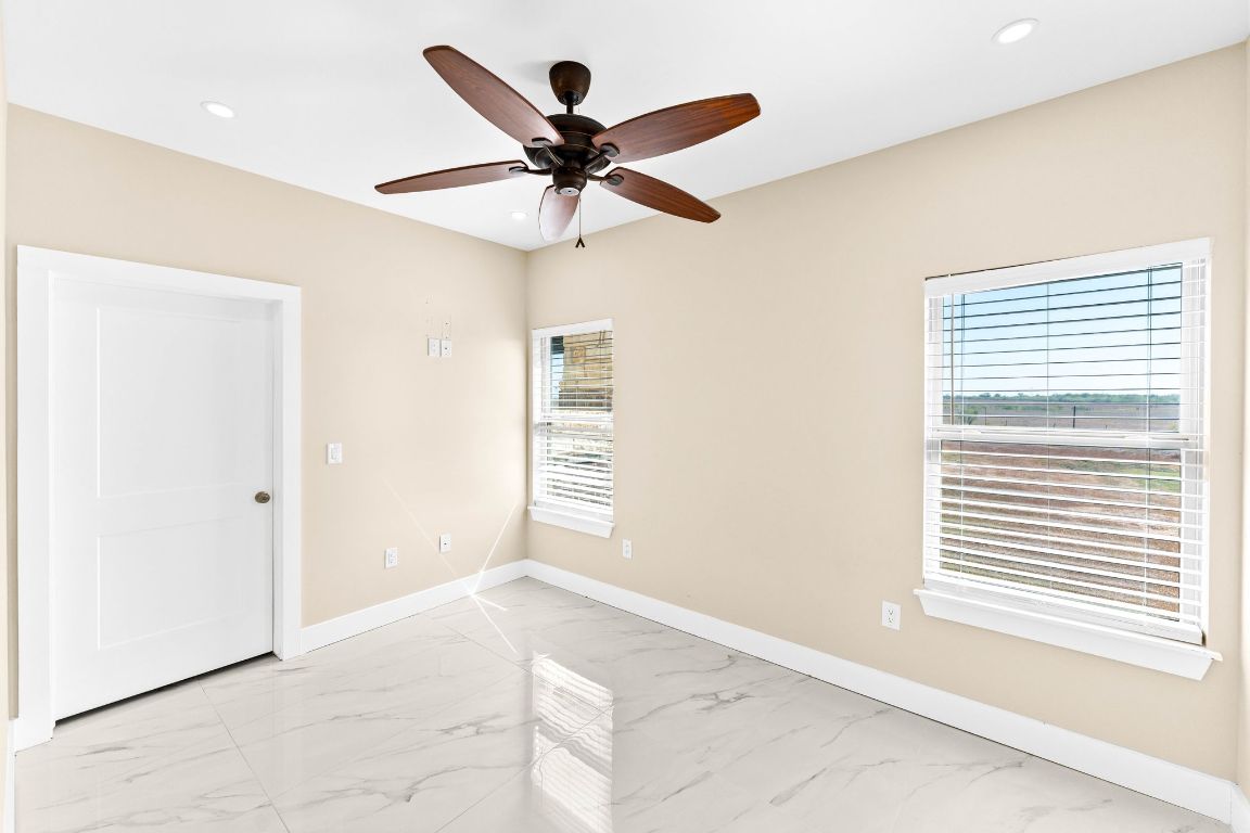 749 El Rey Drive Kyle, TX 78640 - Photo 29 of 40 a view of a livingroom with a ceiling fan and window