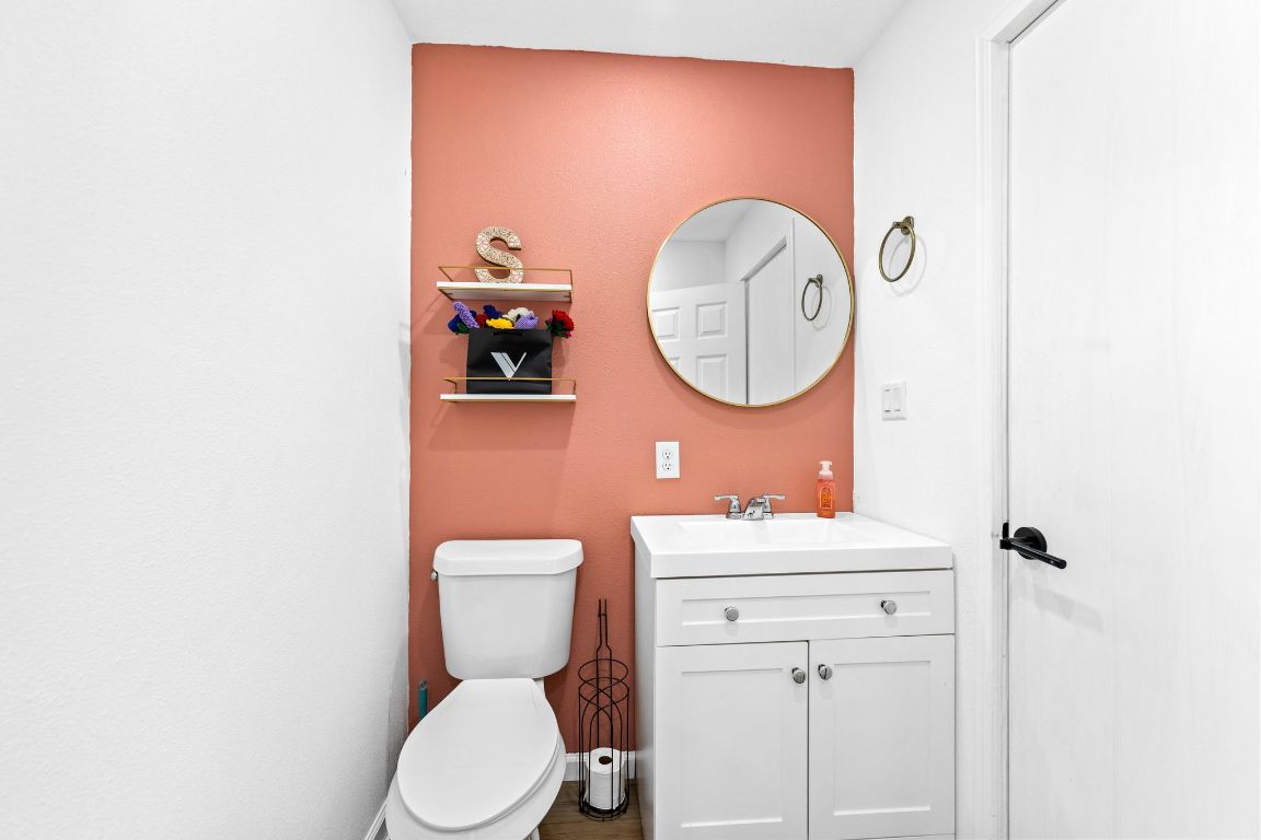 749 El Rey Drive Kyle, TX 78640 - Photo 33 of 40 a bathroom with a toilet a sink and a mirror