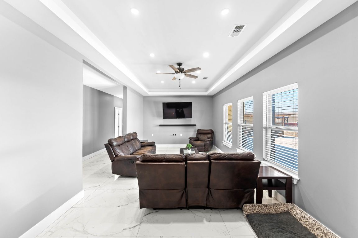 749 El Rey Drive Kyle, TX 78640 - Photo 7 of 40 a living room with furniture and a flat screen tv