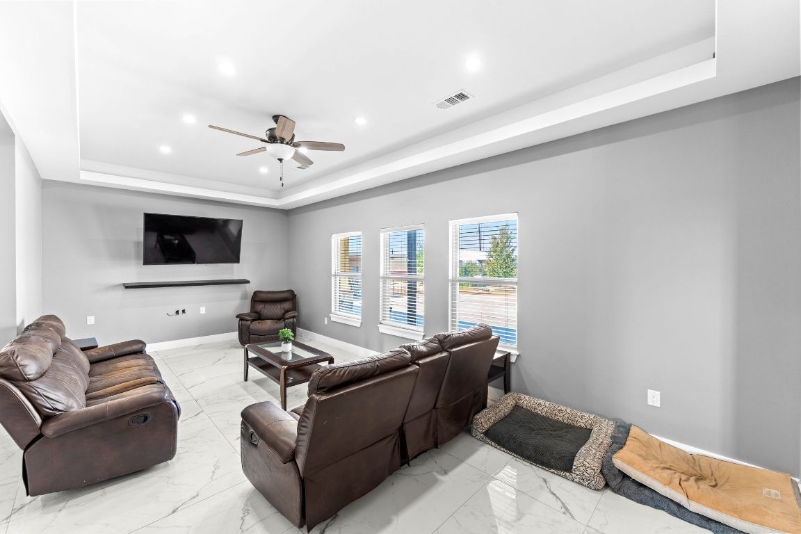 749 El Rey Drive Kyle, TX 78640 - Photo 8 of 40 a living room with furniture and a flat screen tv
