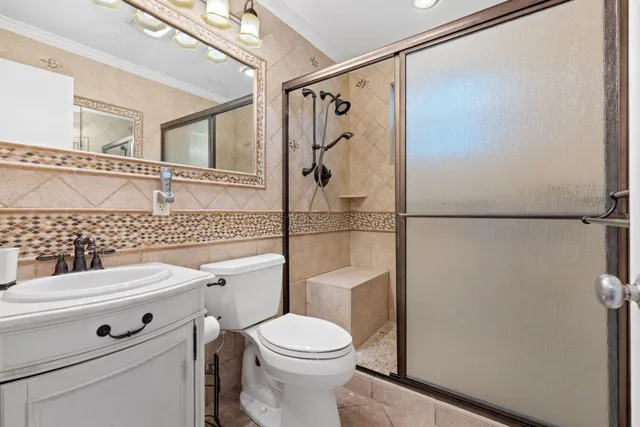 a bathroom with a toilet a sink and a shower