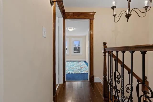 a view of hallway with wooden floor
