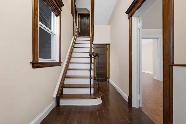 a view of entryway with wooden floor and stairs