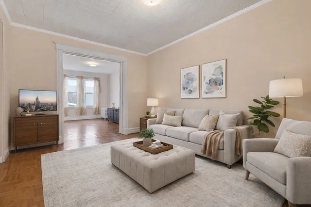 a living room with furniture and a kitchen