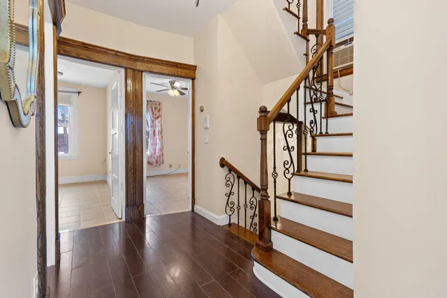 a view of hallway with stairs and wooden floor