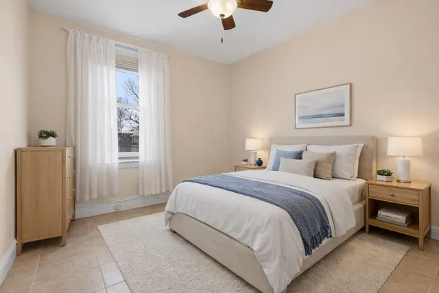 a spacious bedroom with a bed and a chandelier