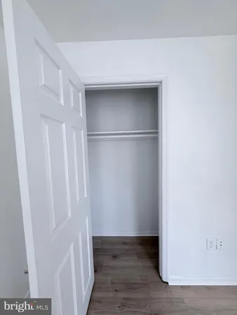 a view of walk in closet with wooden floor