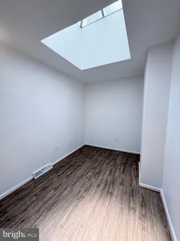 a view of an empty room and wooden floor