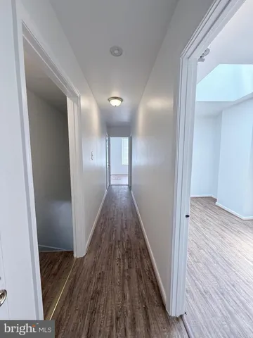 a view of hallway with wooden floor