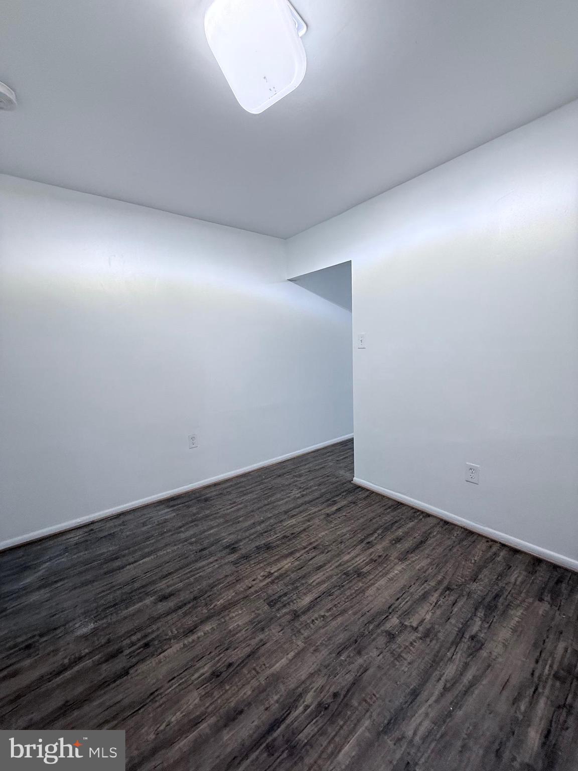 1820 West Fayette Street, Unit 2 Baltimore, MD 21223 - Photo 7 of 26 an empty room with wooden floor and windows