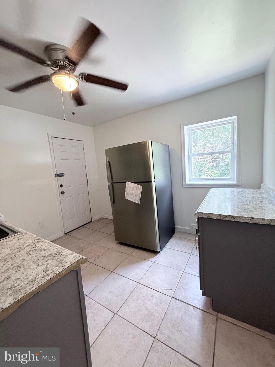 1820 West Fayette Street, Unit 2 Baltimore, MD 21223 - Photo 8 of 26 a living room with hard wood flooring and a ceiling fan