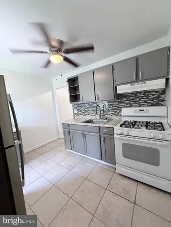 a kitchen with stainless steel appliances a stove a sink and a refrigerator