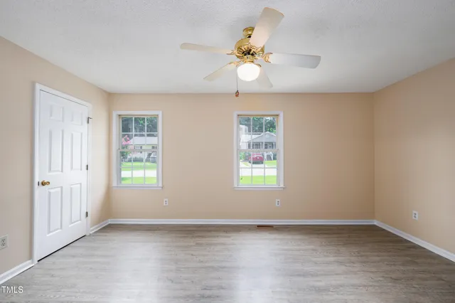 wooden floor in an empty room with a window