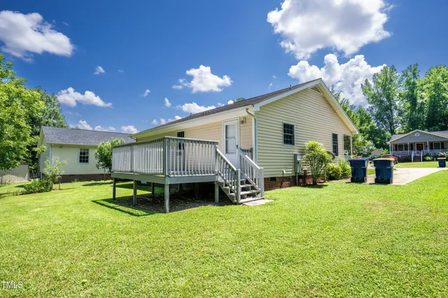 a view of a house with a yard porch and sitting area