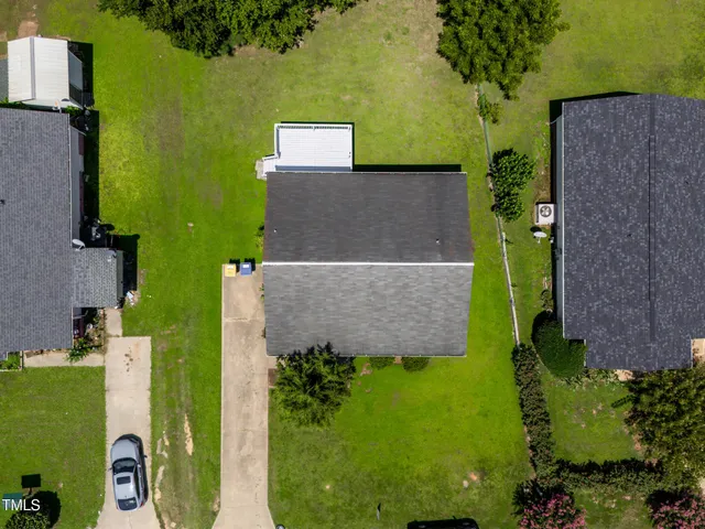an aerial view of a house with a yard