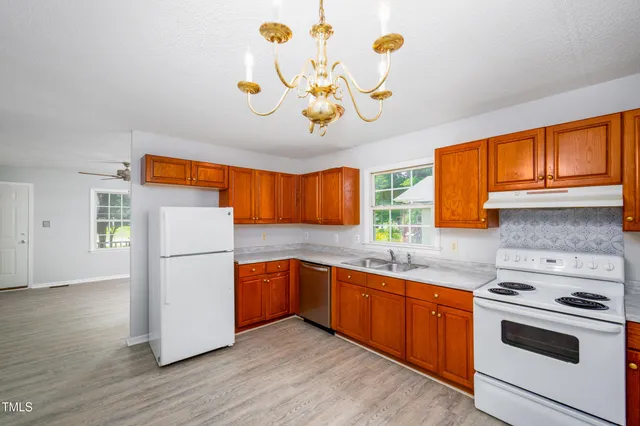 a kitchen with a refrigerator and a sink