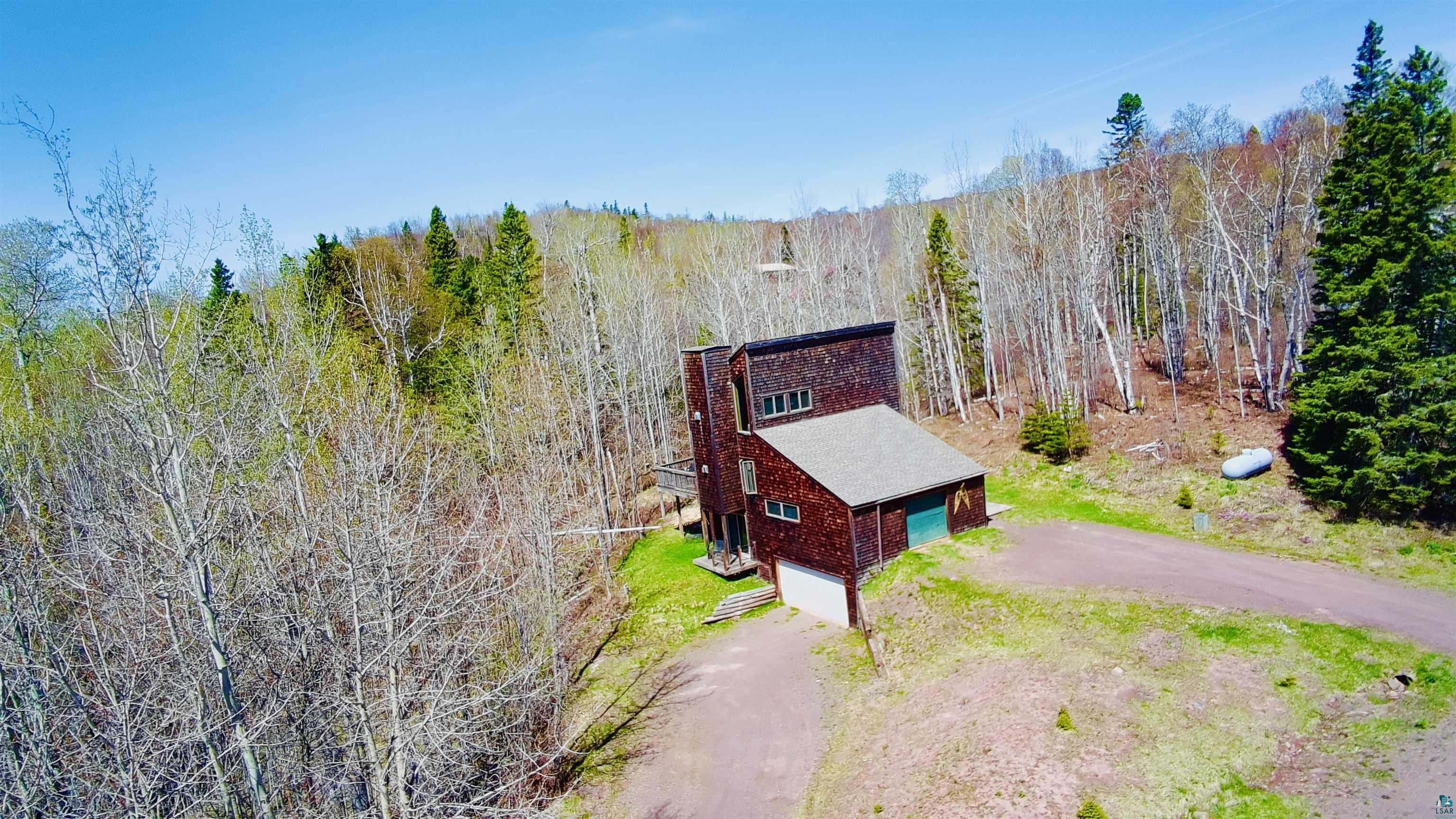 67 Snowshoe Trail Tofte, MN 55615 - Photo 2 of 42 Wood-shingled residence featuring a multi-level design and a pitched roof