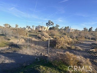 0 Madera Road Phelan, CA 92371 - Photo 3 of 8 a view of a dry yard with wooden fence
