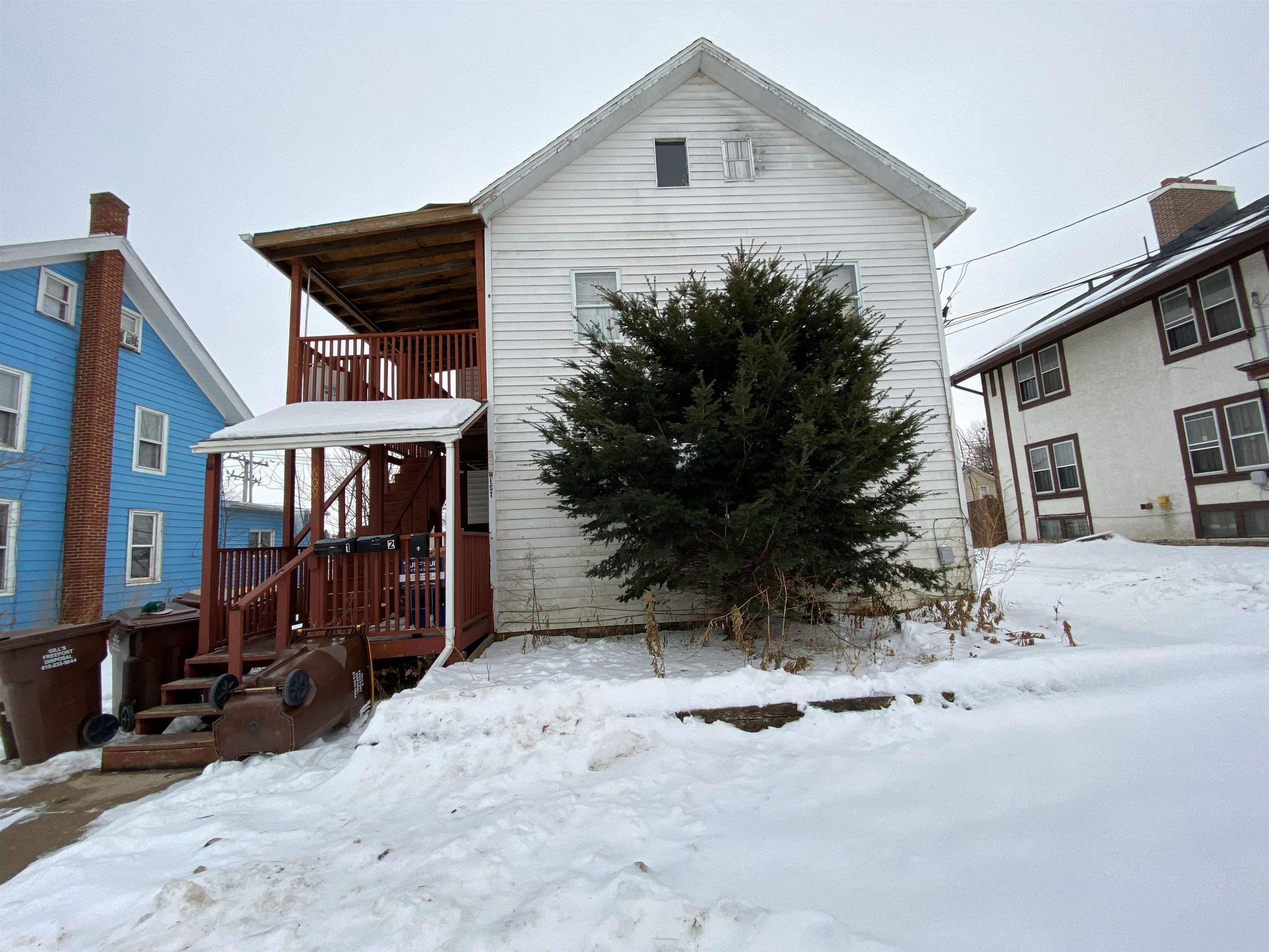 609 West Pleasant Street Freeport, IL 61032 - Photo 1 of 17 a view of a house with a yard covered in snow