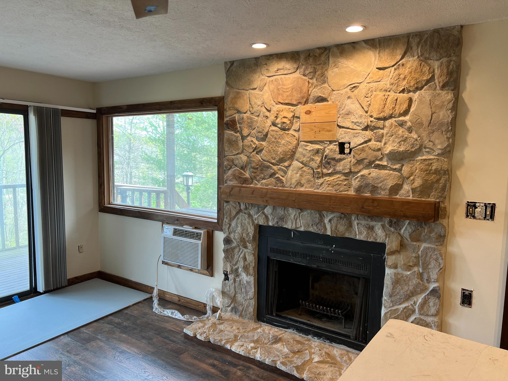 140 The Hill Road, Unit 21B Basye, VA 22810 - Photo 3 of 17 a living room with a fireplace and a fireplace