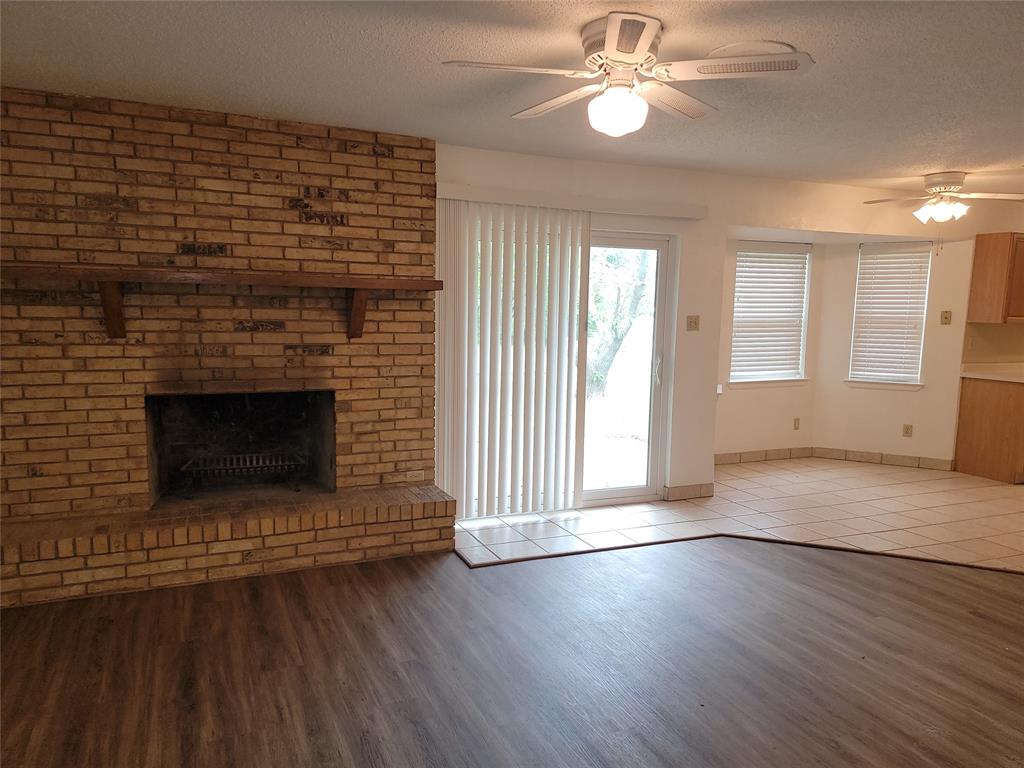1000 Springdale Road Bedford, TX 76021 - Photo 4 of 36 Open the the breakfast nook and kitchen, the living room is naturally lit through the sliding glass door. Ceiling fans added for your comfort.