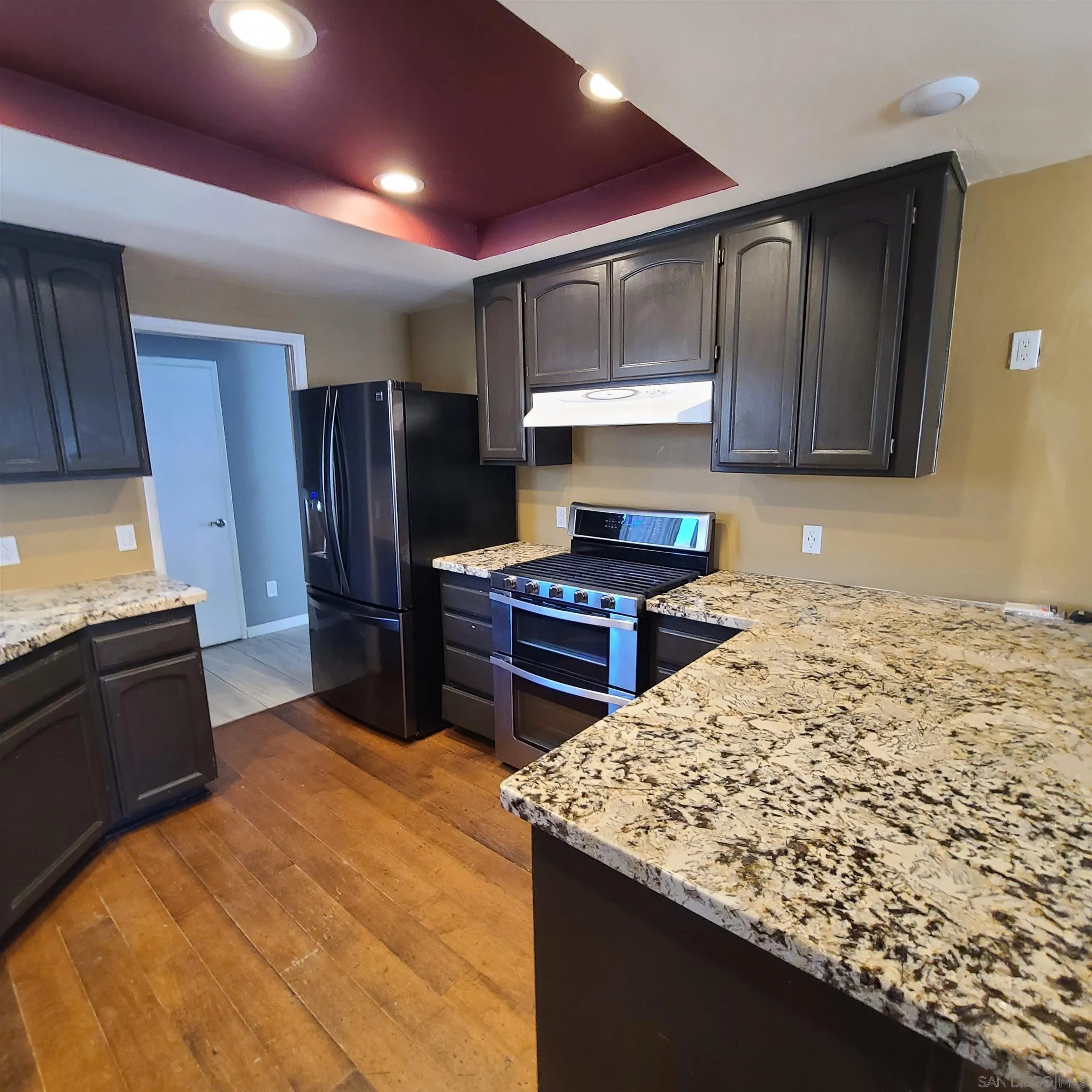 12731 Rios Road San Diego, CA 92128 - Photo 11 of 46 a kitchen with a refrigerator sink and cabinets
