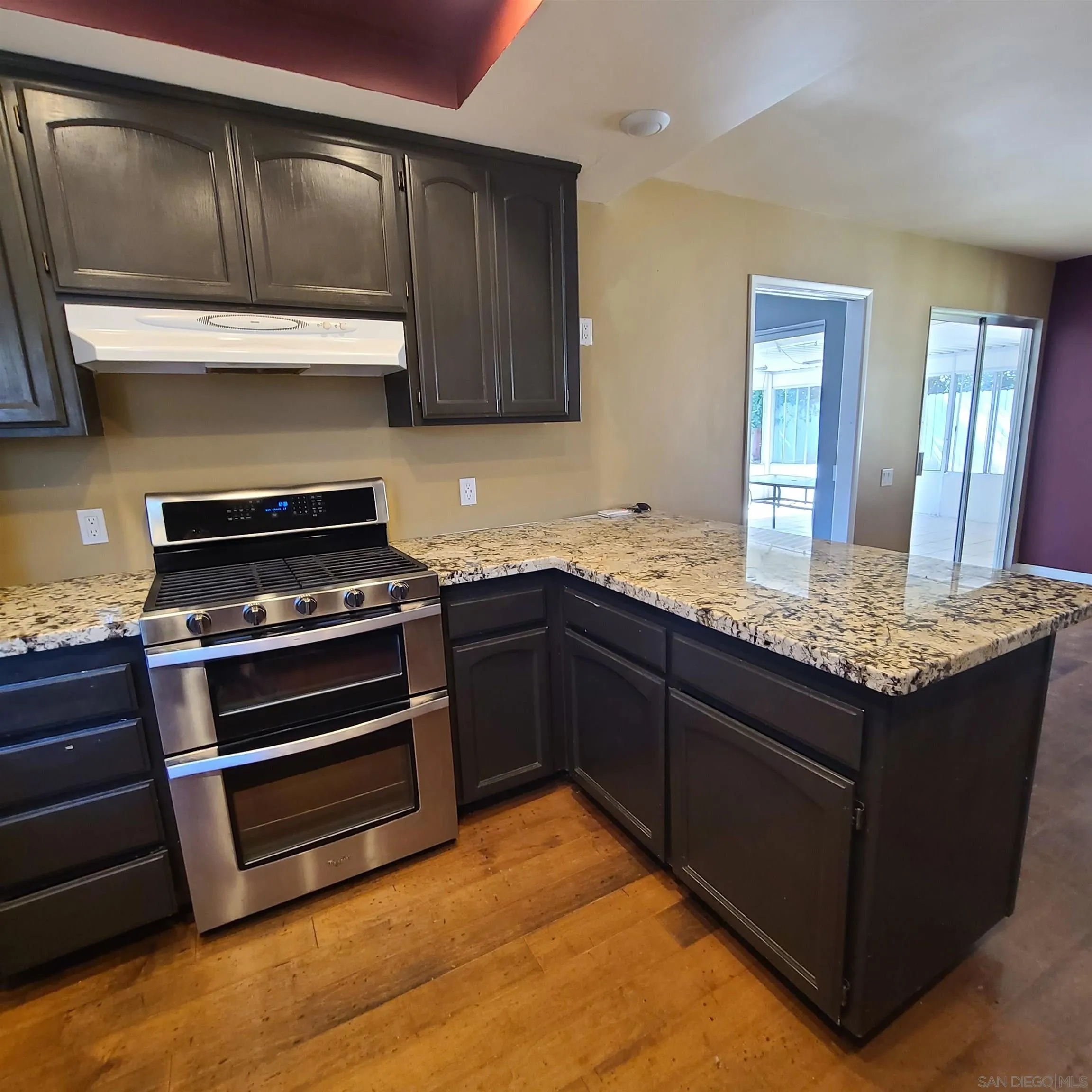 12731 Rios Road San Diego, CA 92128 - Photo 13 of 46 a kitchen with granite countertop a stove and a sink