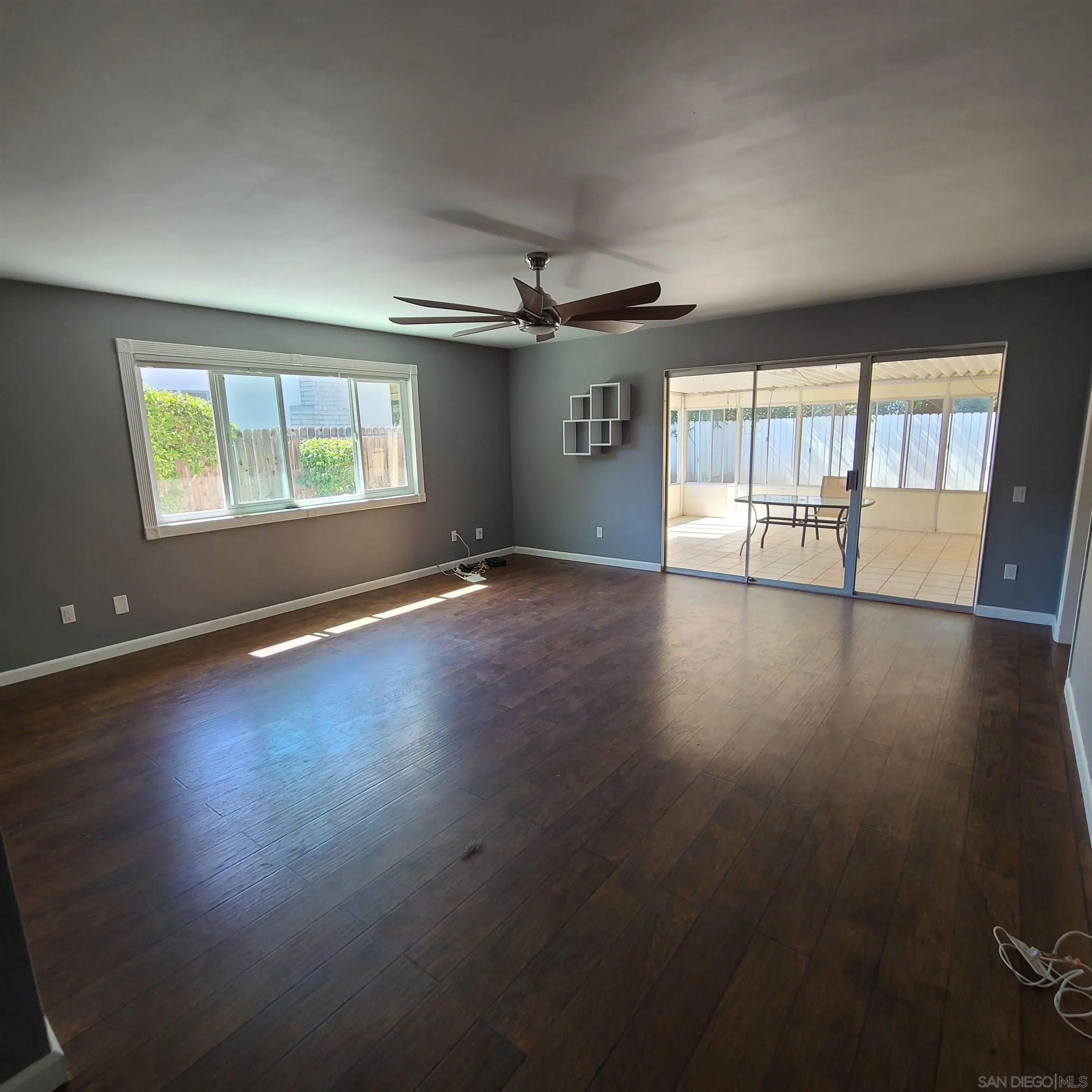 12731 Rios Road San Diego, CA 92128 - Photo 29 of 46 an empty room with wooden floor and windows