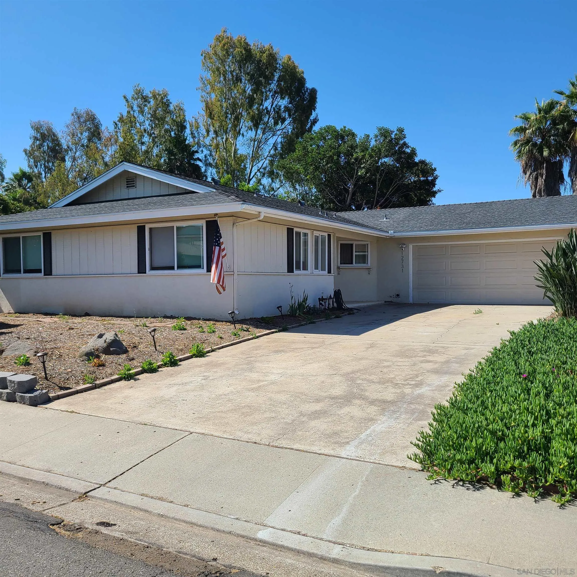 12731 Rios Road San Diego, CA 92128 - Photo 3 of 46 a front view of a house with a yard and trees
