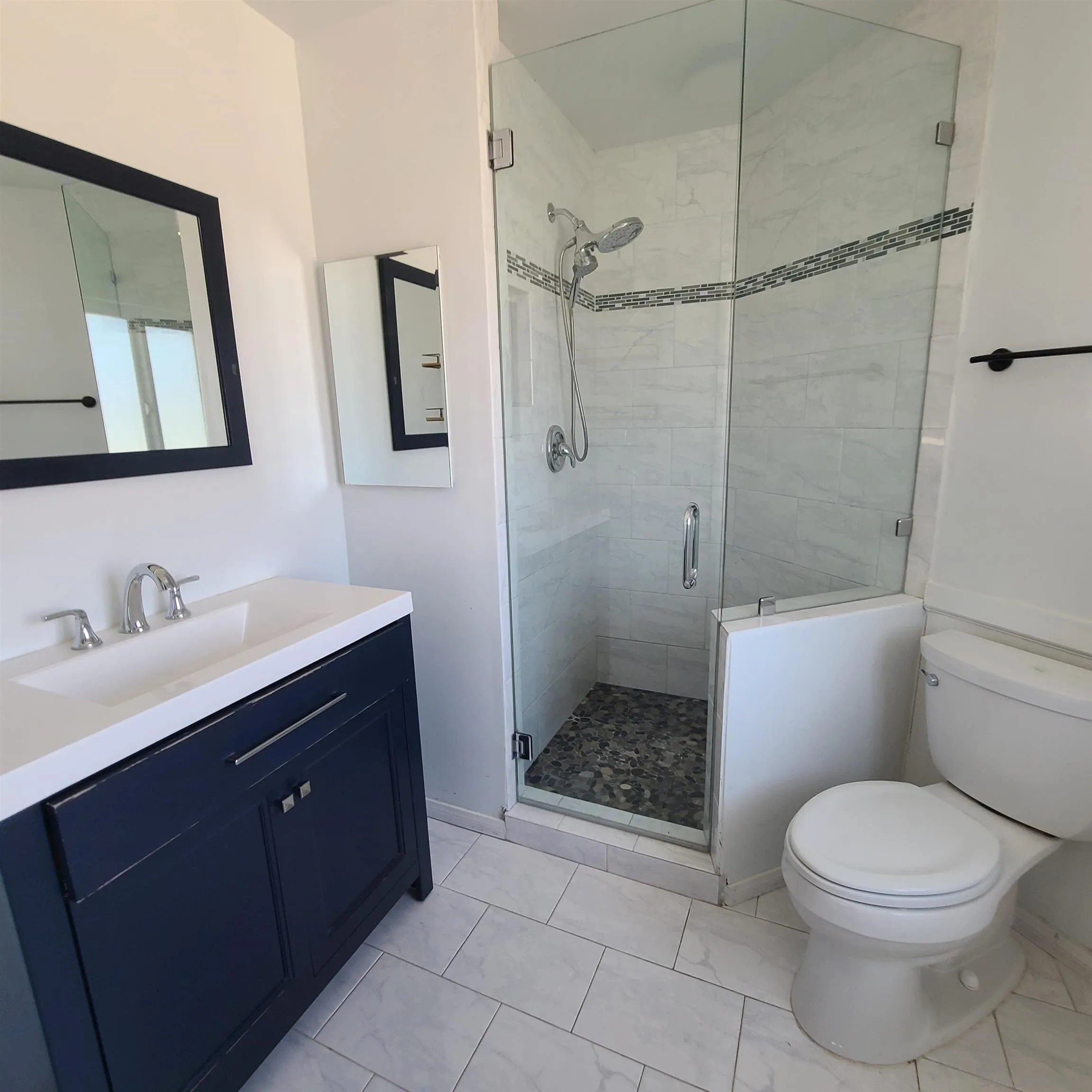 12731 Rios Road San Diego, CA 92128 - Photo 32 of 46 a bathroom with a sink a toilet and shower