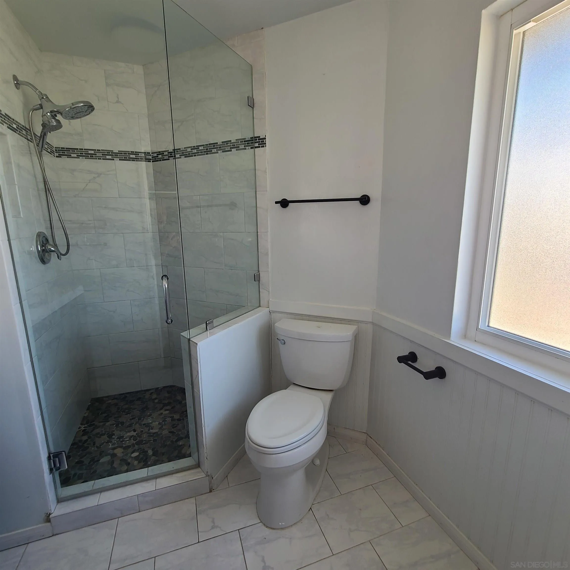 12731 Rios Road San Diego, CA 92128 - Photo 33 of 46 a white toilet sitting next to a shower
