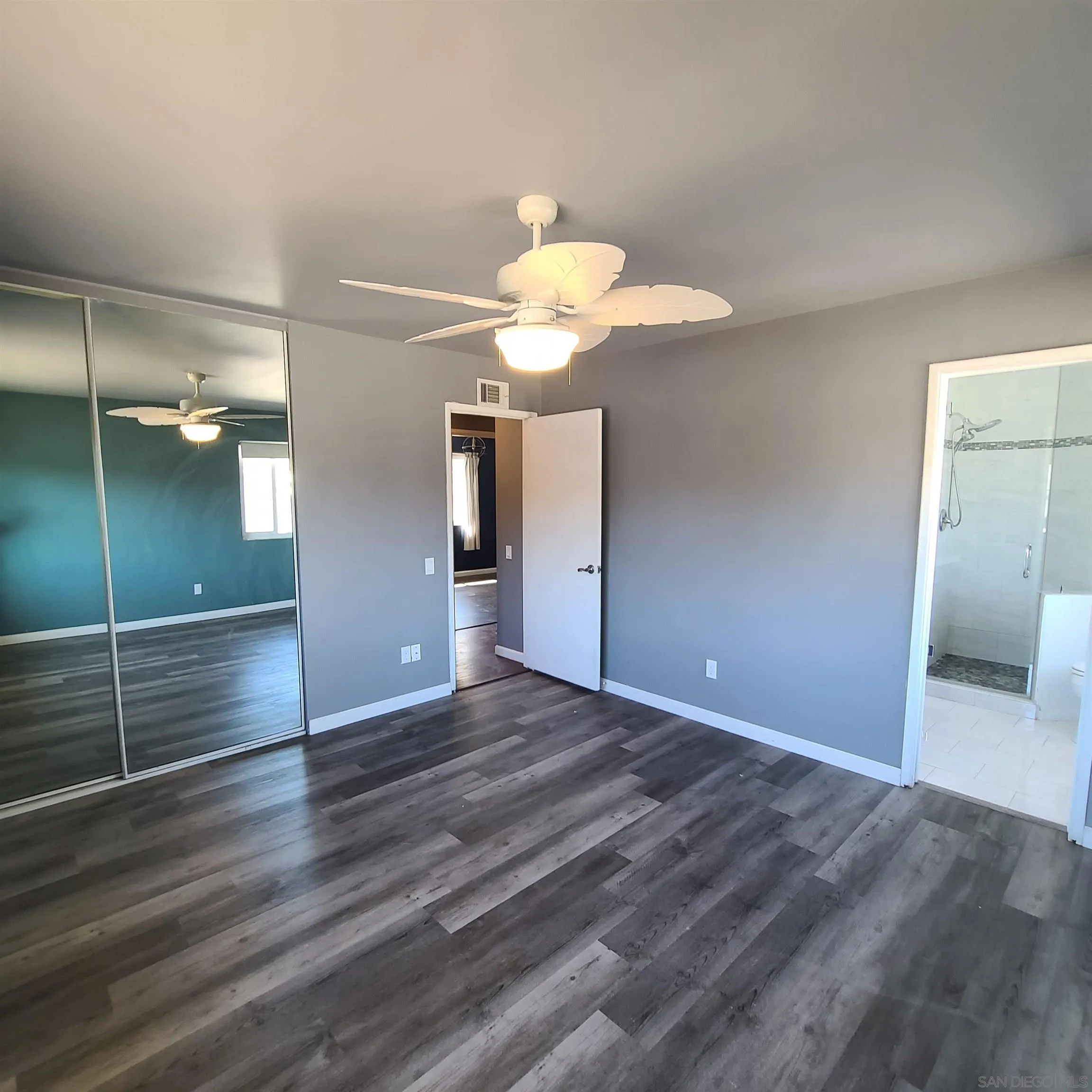 12731 Rios Road San Diego, CA 92128 - Photo 35 of 46 a view of an empty room and window and wooden floor