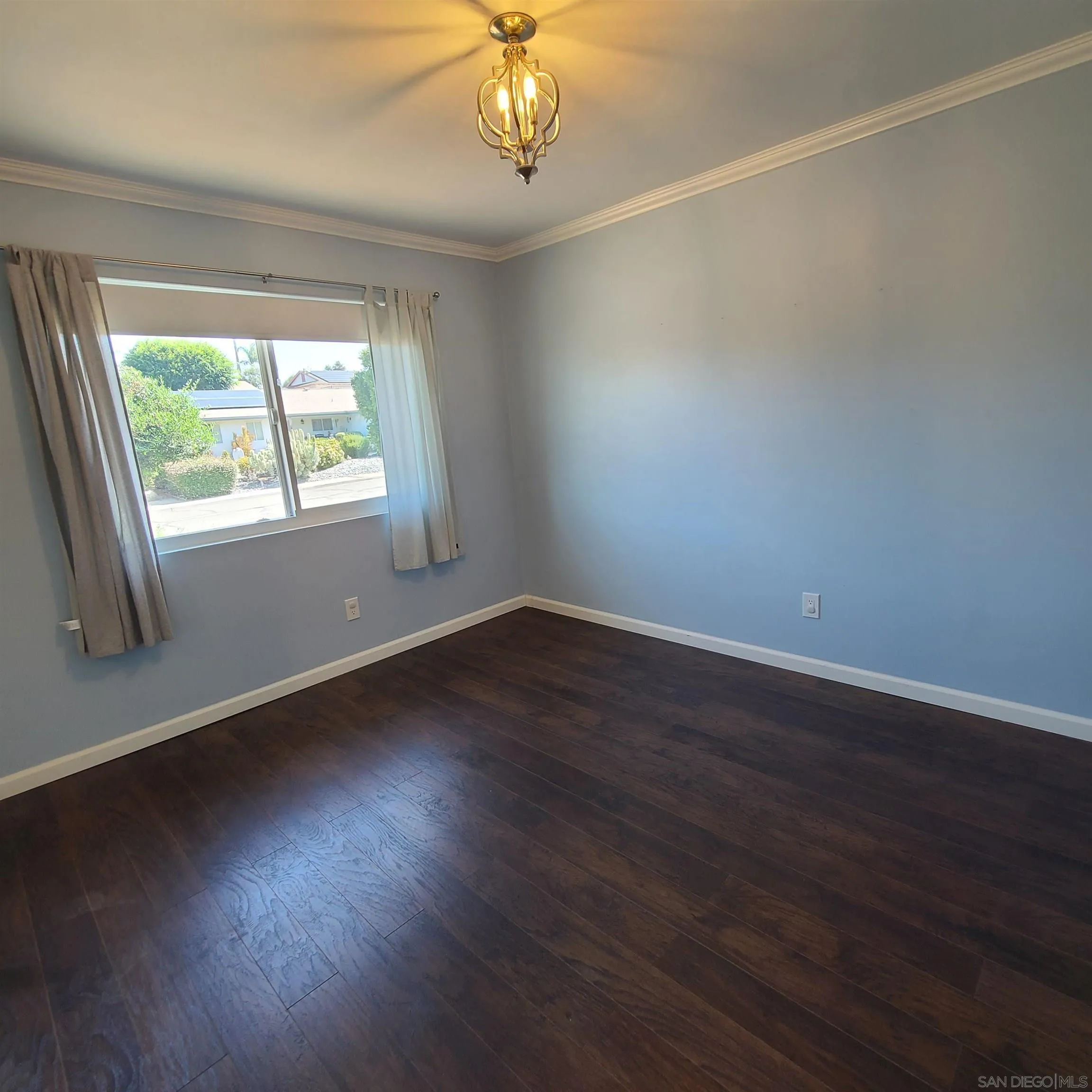 12731 Rios Road San Diego, CA 92128 - Photo 37 of 46 an empty room with wooden floor and windows