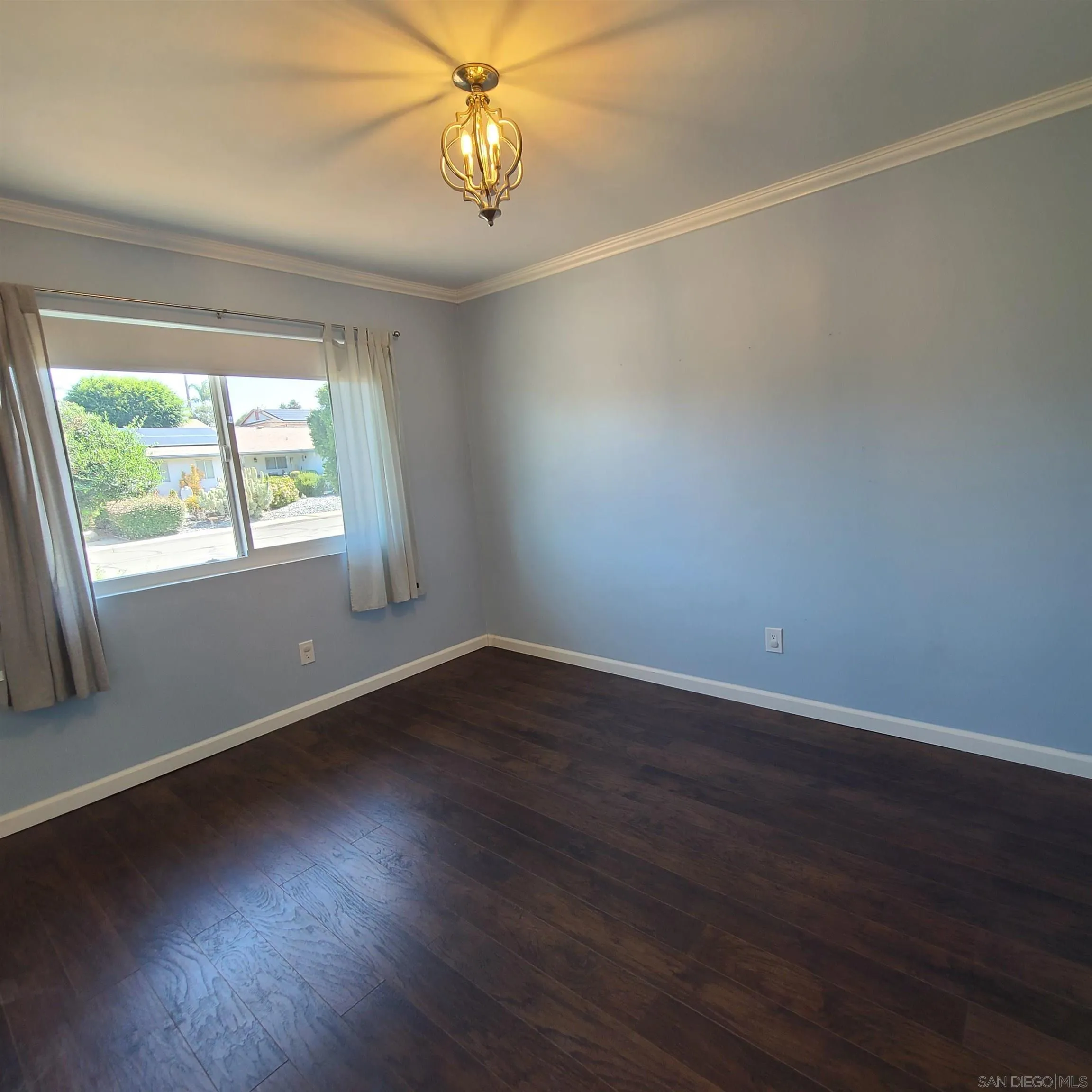 12731 Rios Road San Diego, CA 92128 - Photo 38 of 46 an empty room with wooden floor and windows