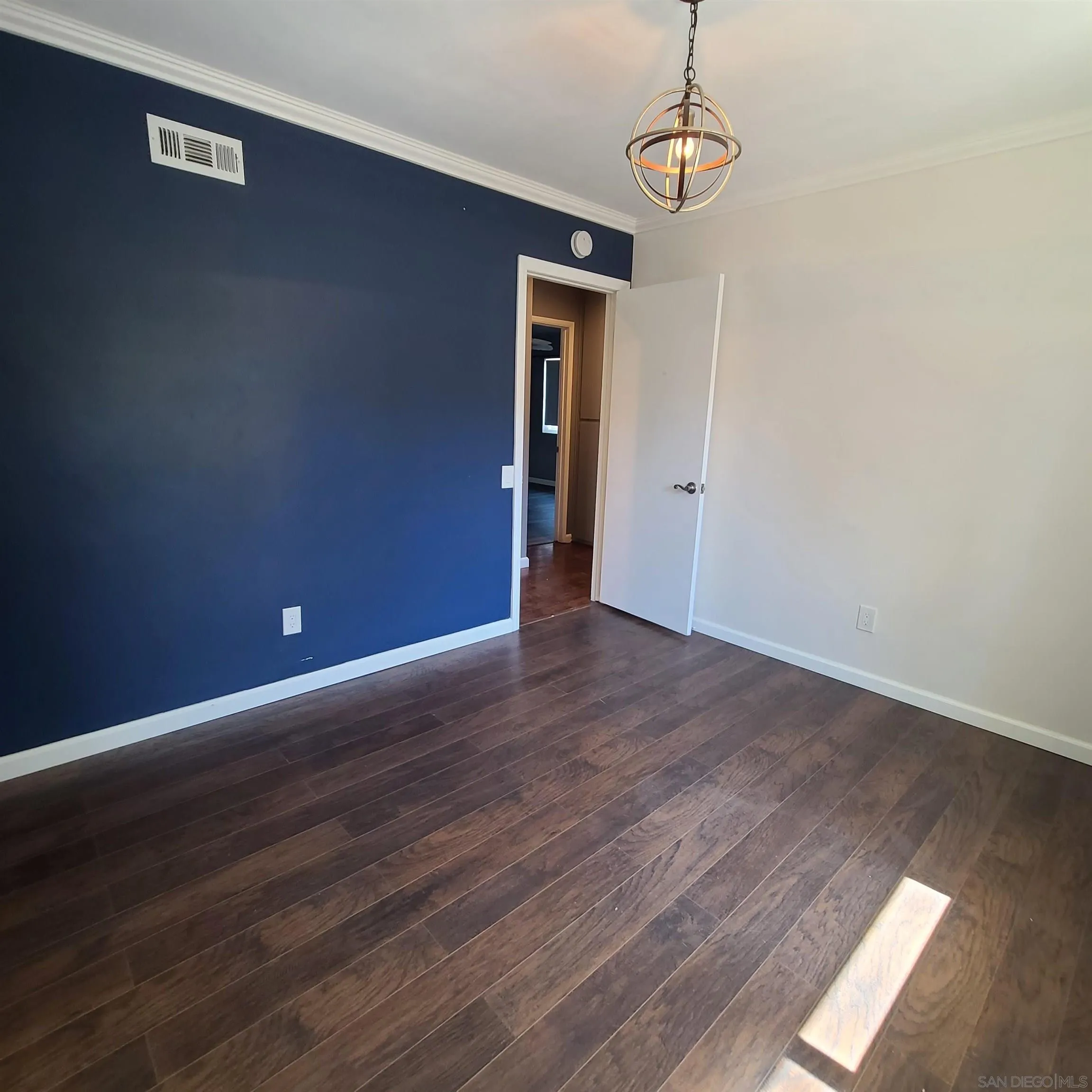 12731 Rios Road San Diego, CA 92128 - Photo 41 of 46 a view of an empty room with wooden floor and window