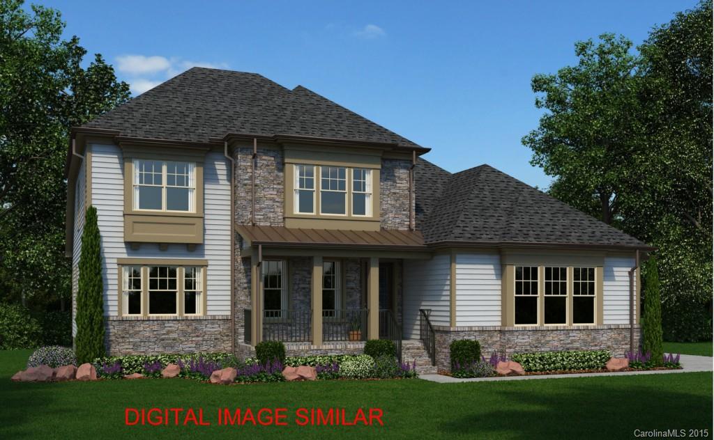 a front view of a house with a garden and plants