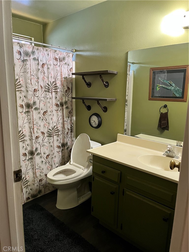 41870 B Street Murrieta, CA 92562 - Photo 13 of 16 a bathroom with a granite countertop toilet sink and mirror