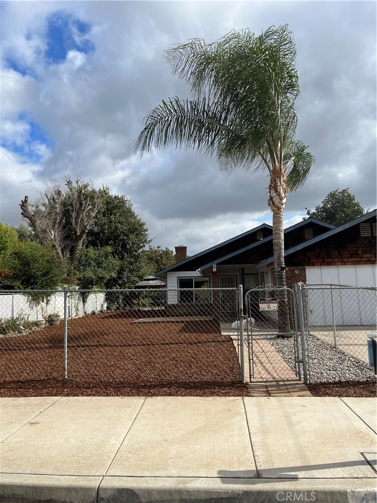 41870 B Street Murrieta, CA 92562 - Photo 2 of 16 a palm tree sitting on a street next to a building