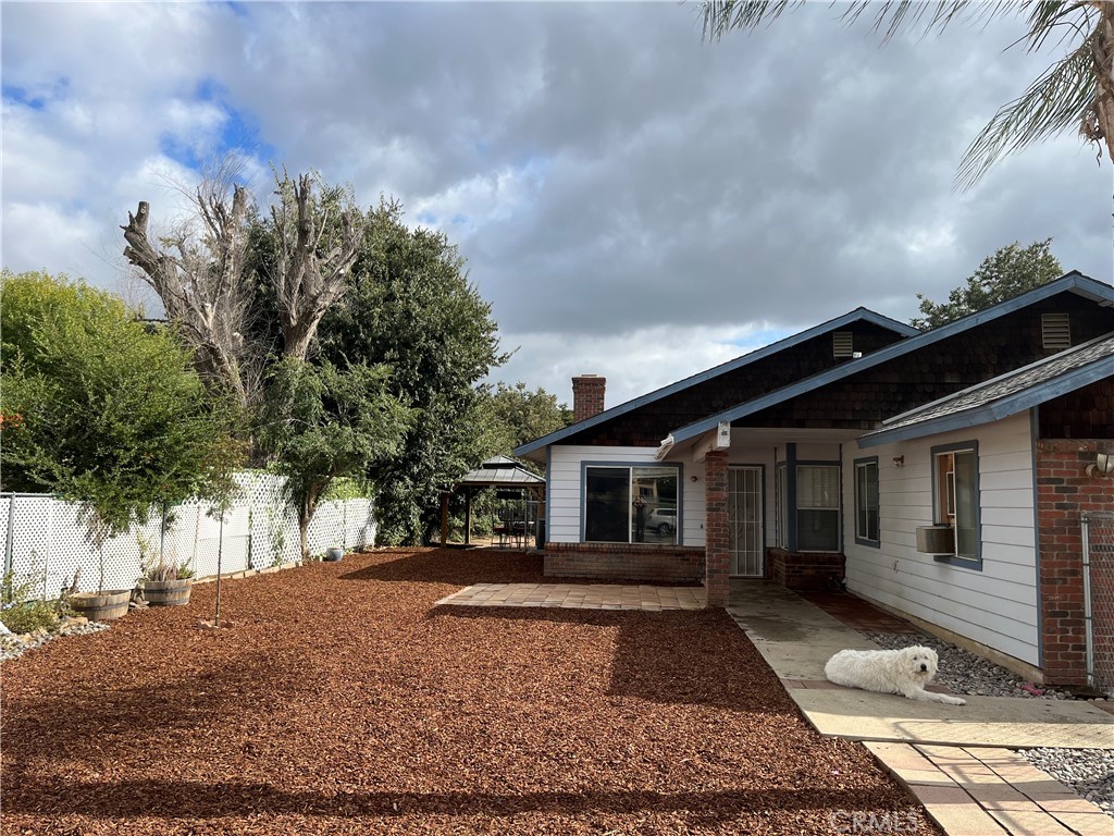 41870 B Street Murrieta, CA 92562 - Photo 3 of 16 a front view of a house with a yard and trees