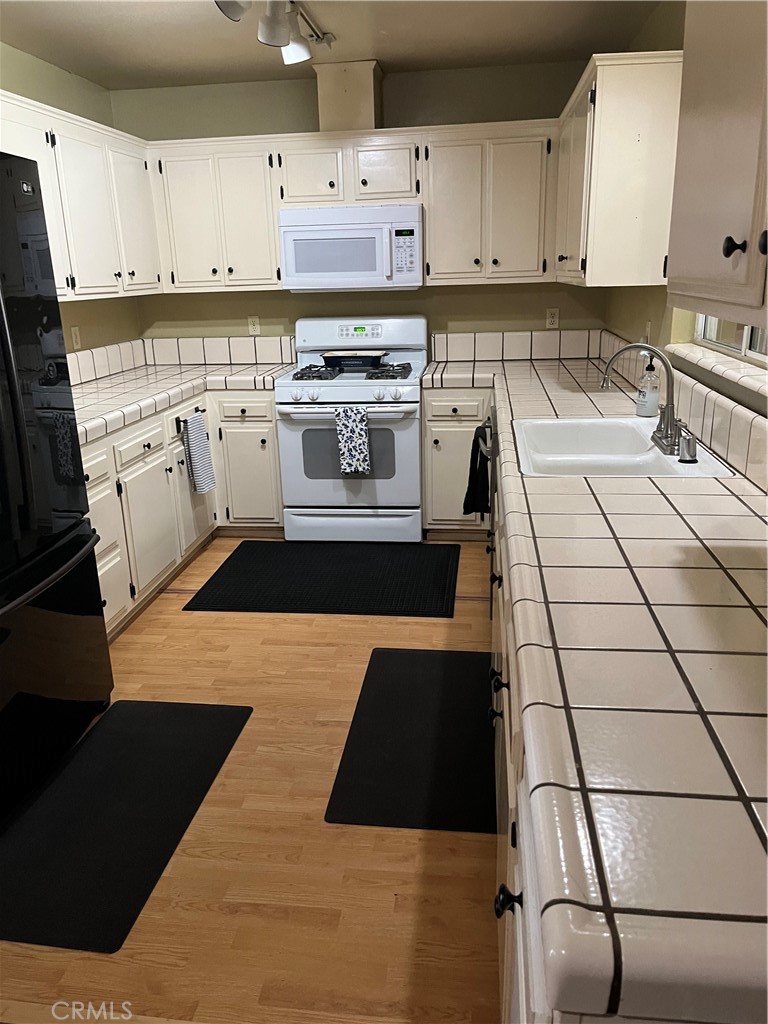 41870 B Street Murrieta, CA 92562 - Photo 7 of 16 a kitchen with a sink and cabinets